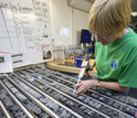 A researcher on a previous IODP expedition labels pieces of core collected while at sea.