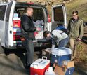 Students pack water samples into a van