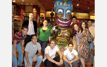 Photo of nine undergraduate students and their professor posing by a statue.