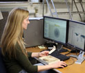 Photo of a researcher entering fossil locality data into a computer.