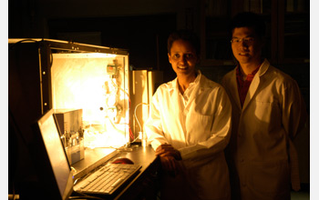 Sossina Haile (left) and William Chueh (right) stand next to thermochemical reactor for H2O and CO2.