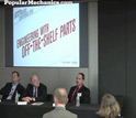 Popular Mechanics automotive editor Larry Webster with discussion panel.
