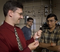 George Huber poses in the laboratory with Hakan Olcay and Tushar Vispute.