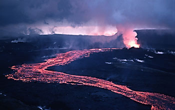 Photo taken at night of incandescent lava flowing downslope from a vent at Iceland's Krafla volcano.