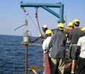 A sediment core is collected from the side of a vessel.
