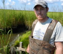 Scientist Matthew Kirwan doing research in Chesapeake Bay wetlands.