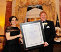 Photo of NSB's France Córdova presenting NSB's Public Service Award for a group to Dennis Bartels.