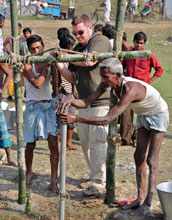 graduate student Thomas Hartzog assisting in the drilling of a tube well in Bangladesh.
