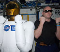 Photo of dexterous humanoid helper Robonaut 2 with Scott Kelly in International Space Station lab.