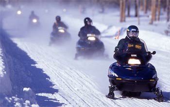 Several people on their snowmobiles.