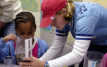 Photo of a girl and woman engaged in a hands-on science experiment