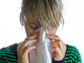 a woman wiping her nose with a tissue