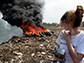 Heidi Vreeland looking at roadside trash burning in India