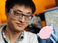 Yi Zhang holding a porous solid material