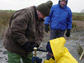WHOI geologist use an auger to bore holes