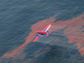an airplane sprays chemical dispersants on an oil slick in the Gulf of Mexico