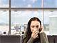 a woman wiping her nose while talking on a cell phone