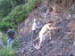 photo of geologists digging into a shale exposure