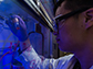 Yifan Zhu holds a vial of photosensitive, semiconducting quantum dots